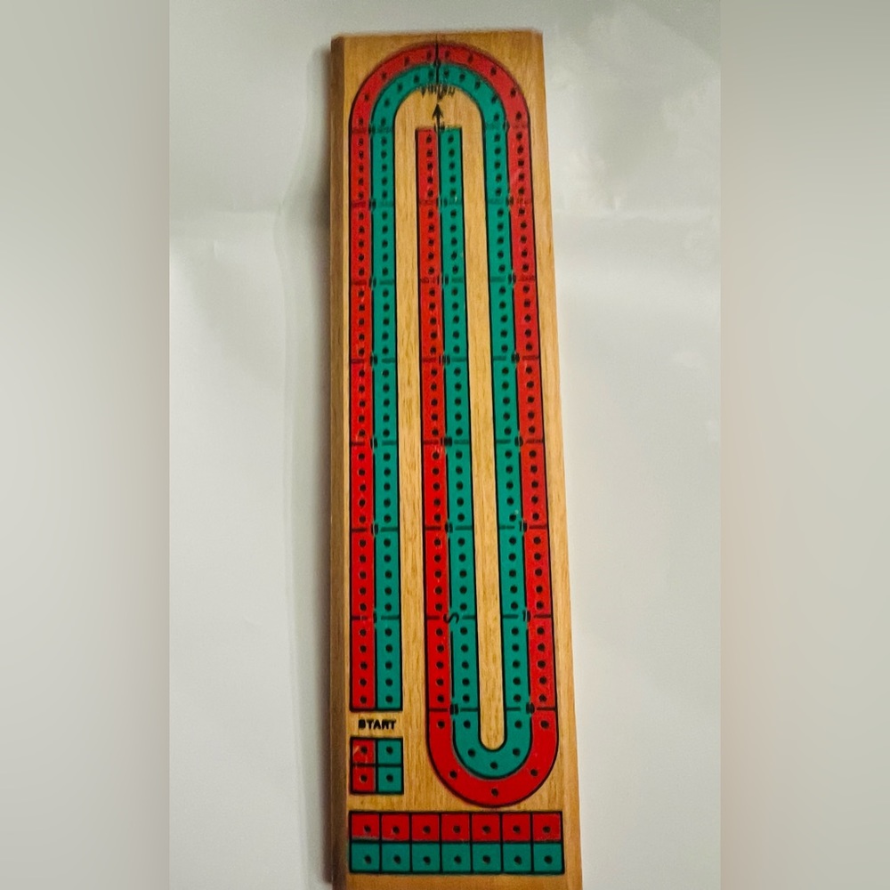 Wooden cribbage game board with pegs